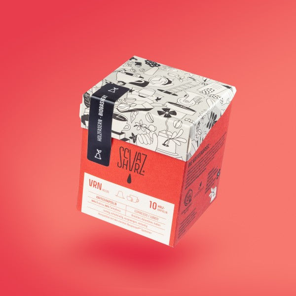 Produktbild Kapselbox vor rotem Hintergrund Sorte VRN.Produktbild Kapselbox vor rotem Hintergrund Sorte VRN.